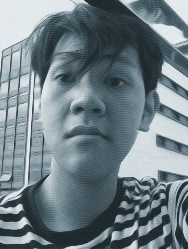 Portrait of Trần Trung Dũng in a striped shirt, in front of an office building